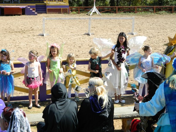 Kids at the costume contest (the banner was painted by Oona, aged 4, and it reads "Fulshear Dragon Riders")
