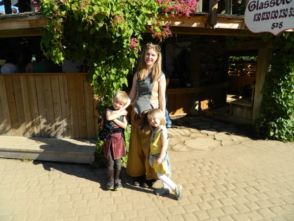 A dragon riding instructor and her two prize pupils at a glass blower's shop (costumes and photo by E.G.D.)